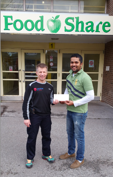 Orlando Martín López Gómez of FoodShare receiving a cheque at the Crotia Street headquarters